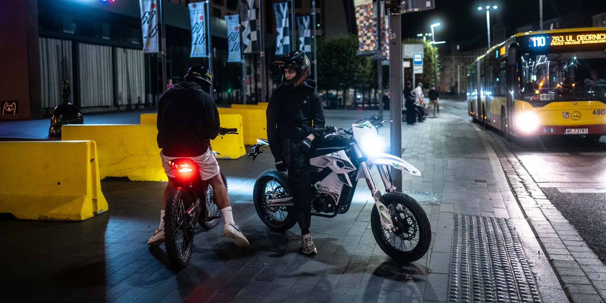 Neon-lit alley with pedestrians at dusk