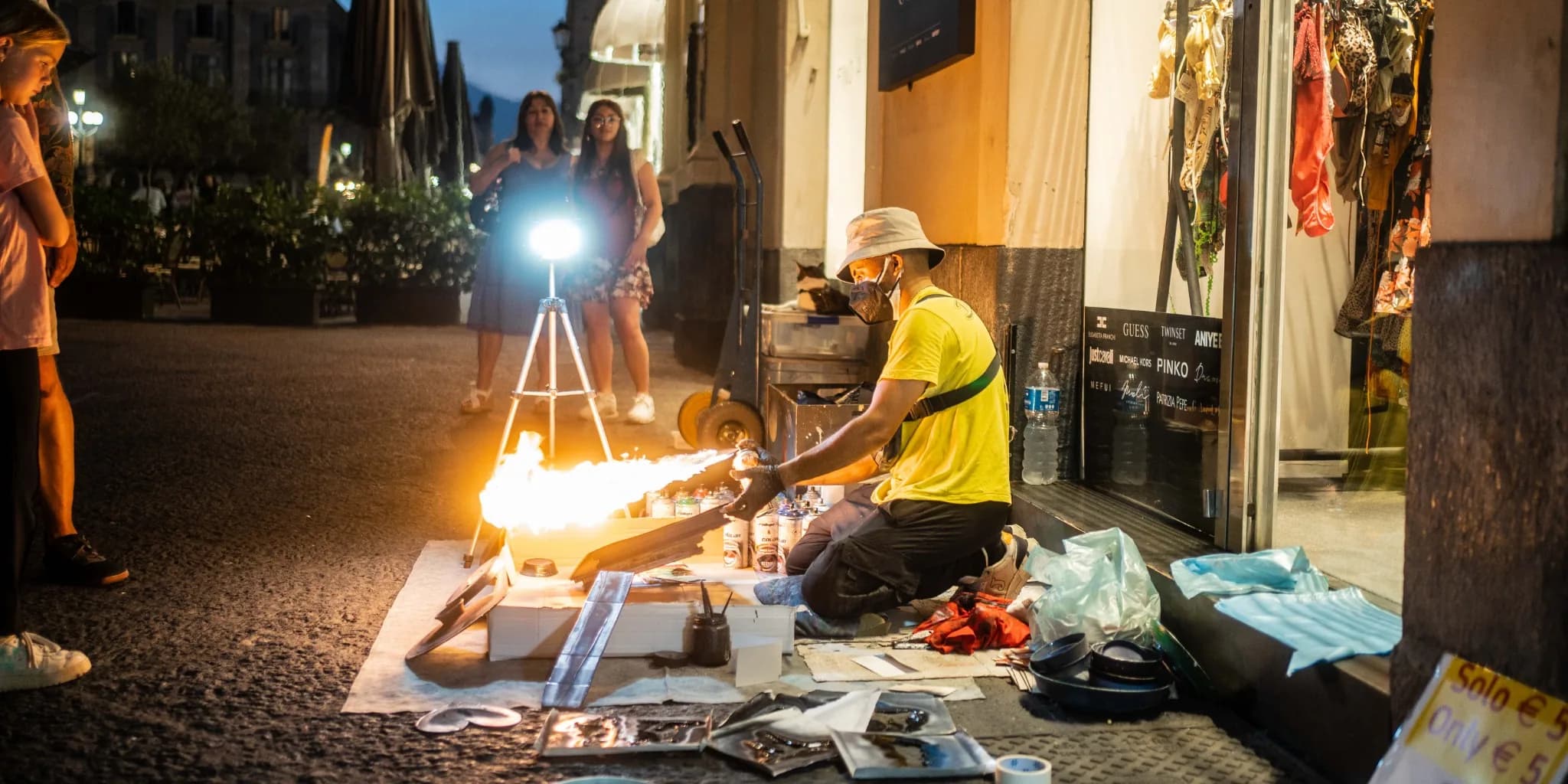 Street artisan working with fire at night