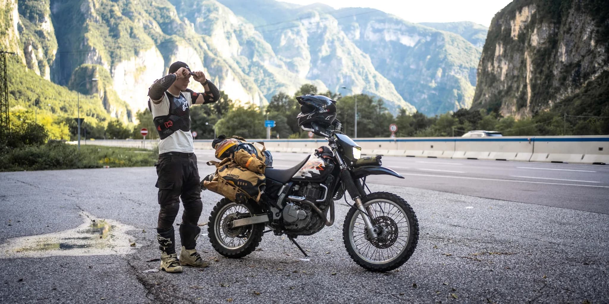 Motorcycle and rider in a mountain valley
